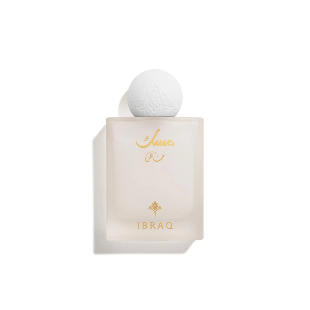A bottle of Ibrahim perfume with a frosted pale pink rectangular glass body, gold lettering, and a white spherical cap, shown on a white background with a soft shadow.