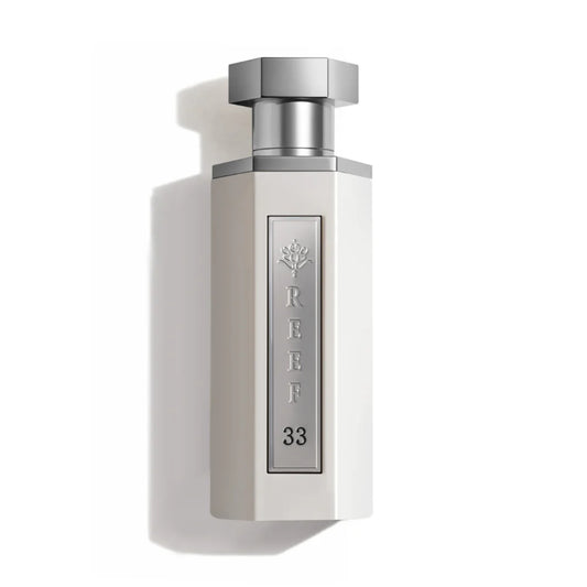 White perfume bottle with silver cap on a white background