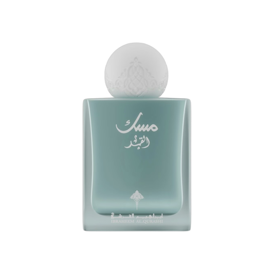 A square glass perfume bottle with a rounded, frosted pale aqua body and a spherical frosted cap, featuring white Arabic script on the front.
